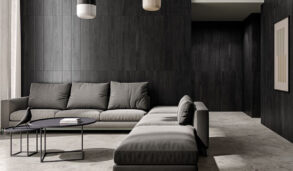 Luksuriøs stue med store, grå gulvfliser og fondvegg i en mørk kontrastfarge